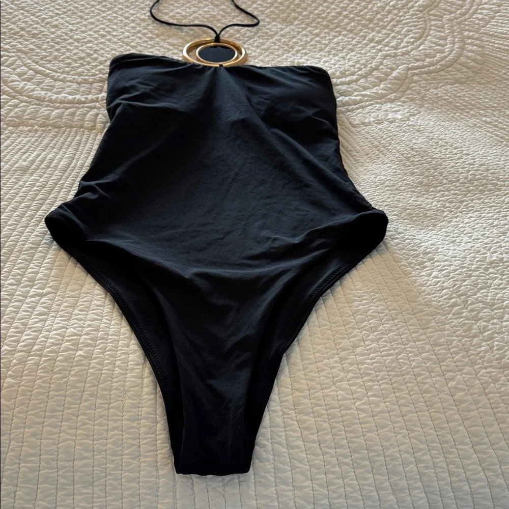 Black swimsuit with gold hardware detailing